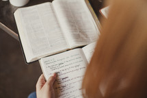 reading a Bible and writing in a journal during a Bible study