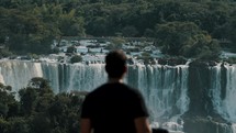 Man Looking At The Iguazu Falls In Argentina And Brazil Border. - wide shot