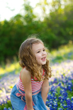 girl child in a field of Blue bonnets