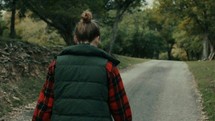teen girl walking down a rural road 