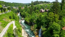 Aerial shot drone flies along river and waterfalls in Rastoke, Croatia