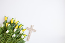 Cross with yellow and white tulips on a white background