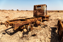 old rusty metal truck in a hot desert 