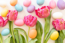 Pink tulips and Easter eggs on white