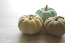 small pumpkins on a wood background 