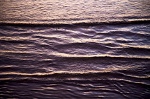 ripples in ocean water along a shore 