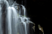 waterfall cascading down rocks slow shutter speed