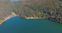 Aerial View Of Saint Anne Lake, Crater Lake At Ciomatu Mare Volcano With Dense Forest In Romania.