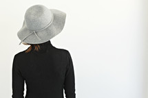 a woman wearing a gray hat 