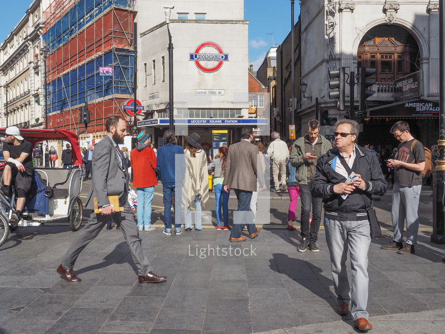 LONDON, UK - JUNE 10, 2015: Travellers at Leicester Square underground station