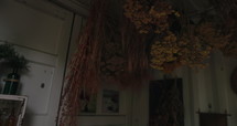 Flowers hang drying from ceiling of house - close up