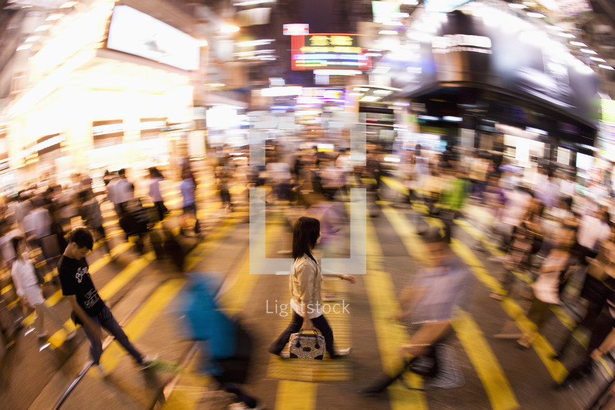 Unrecognisable woman crossing a road in Hong Kong, China. Asia. - for editorial use only 