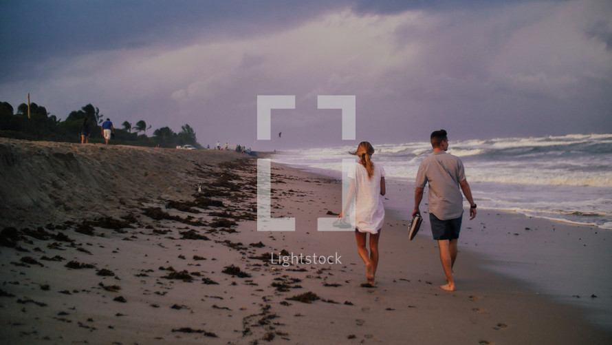 couple strolling on a beach 