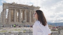 A tourist woman on summer vacations on the the Parthenon Temple at the Acropolis of Athens, Greece