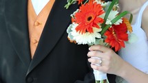 bride and groom holding a bouquet 