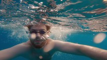 Man swimming breaststroke style in the open sea water