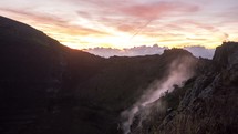 time-lapse of steam rising from a mountain a sunrise 