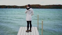 a woman standing on a pier 