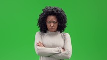Woman crossing her arms in disappointment on green screen