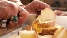 Slow motion cutting potato pieces with a sharp knife