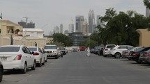 Cars on street with distant buildings in Dubai.