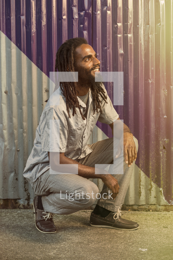  jamaican man with dreadlocks looking up to God 