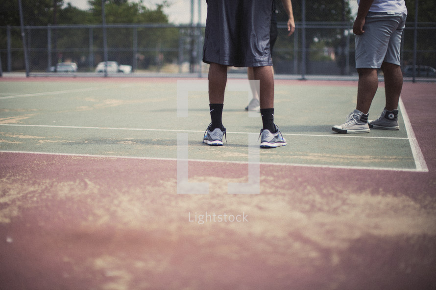 Men's legs on a basketball court.