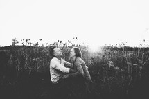 a couple sitting in a field 