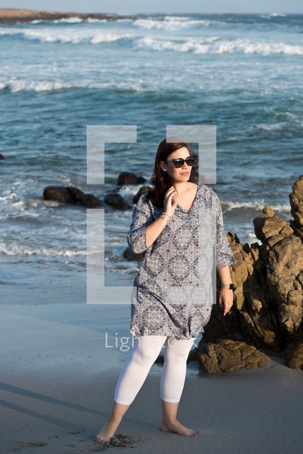 a woman standing on a beach 