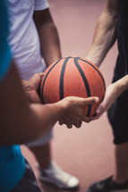 Player's hands holding a basketball.