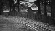 Old narrow gauge steam train in the countryside filmed in B/W.
