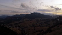 Mountain landscape in cloudy cloudy weather, Forests and pastures. End of winter. Hyperlapse, Aarial view,