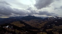 Mountain landscape in cloudy cloudy weather, Forests and pastures. End of winter. Hyperlapse, Aerial drone view