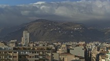 Timelapse of clouds over Palermo, Italy. City scene with green hills