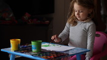 child painting with paints 