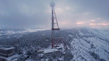 Communication mast on a snowy hill