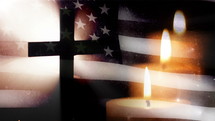 Cross with US flag and three candles.