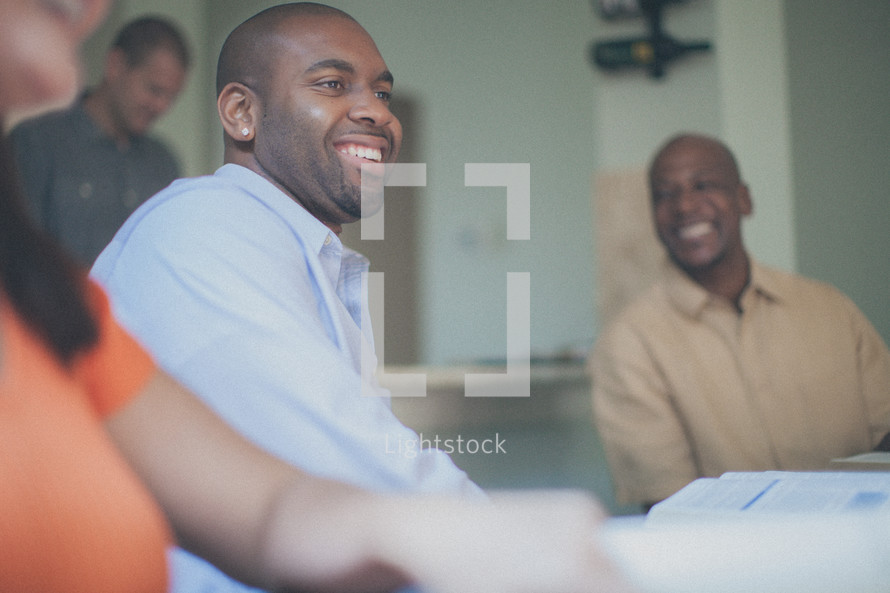 men smiling at a small group Bible study 