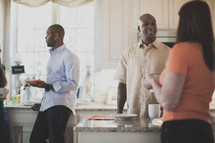people in conversation in a kitchen at a Bible study 