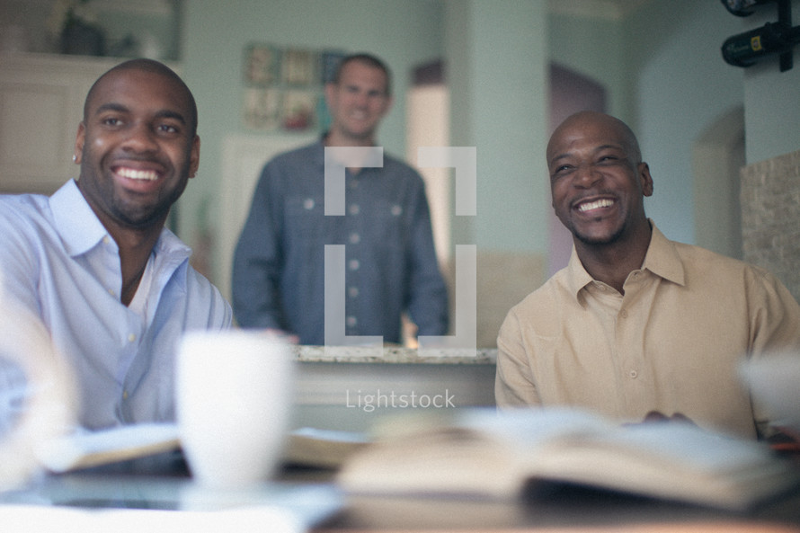 men smiling at a small group Bible study 