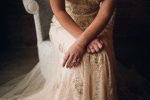 a woman in a wedding dress sitting 