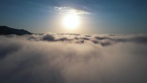 Fly above the clouds at sunset