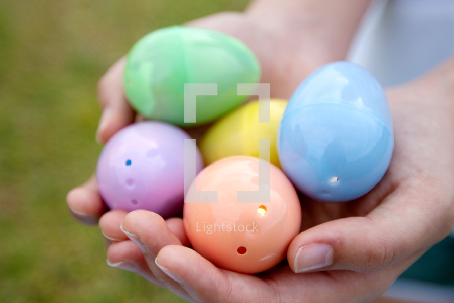 cupped hands with Easter eggs 