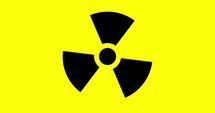 rotating caution radiation area warning sign in black over yellow