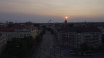 A timelapse capturing Szeged, Hungary, as it transitions from daylight to nighttime, showcasing historic buildings, busy streets, and urban life