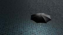Black umbrella hovering above blue tile