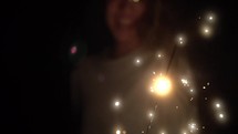 woman holding a sparkler 