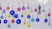 A lot of blue nazar eye sign hang on wall. Small local shop in Turkey. Amulet from the evil eye, protection of the house, superstition.