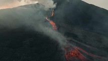 Drone aerial landscape shot of lava flowing from volcano activity in Guatemala.