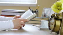 Young woman reading the Bible at home and begins to pray in her devotional time. Dolly shot closeup. 